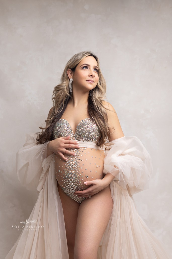 mom poses in a rhinestone bodysuit and robe during a maternity session in clark nj