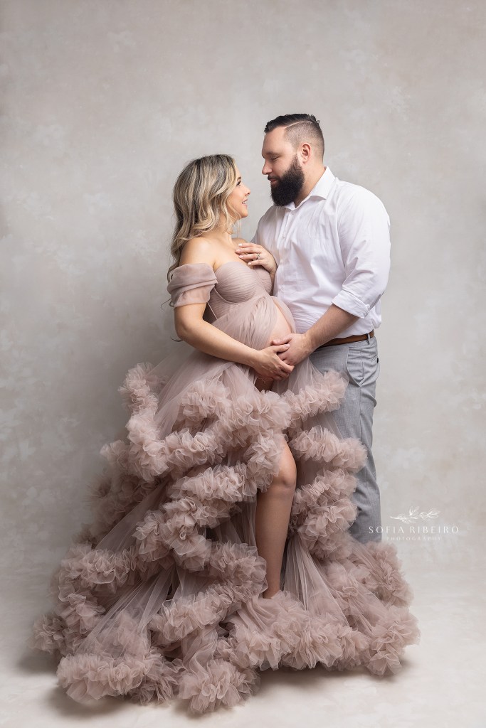 mom and dad look lovingly at each other during a nj maternity photo session in clark nj