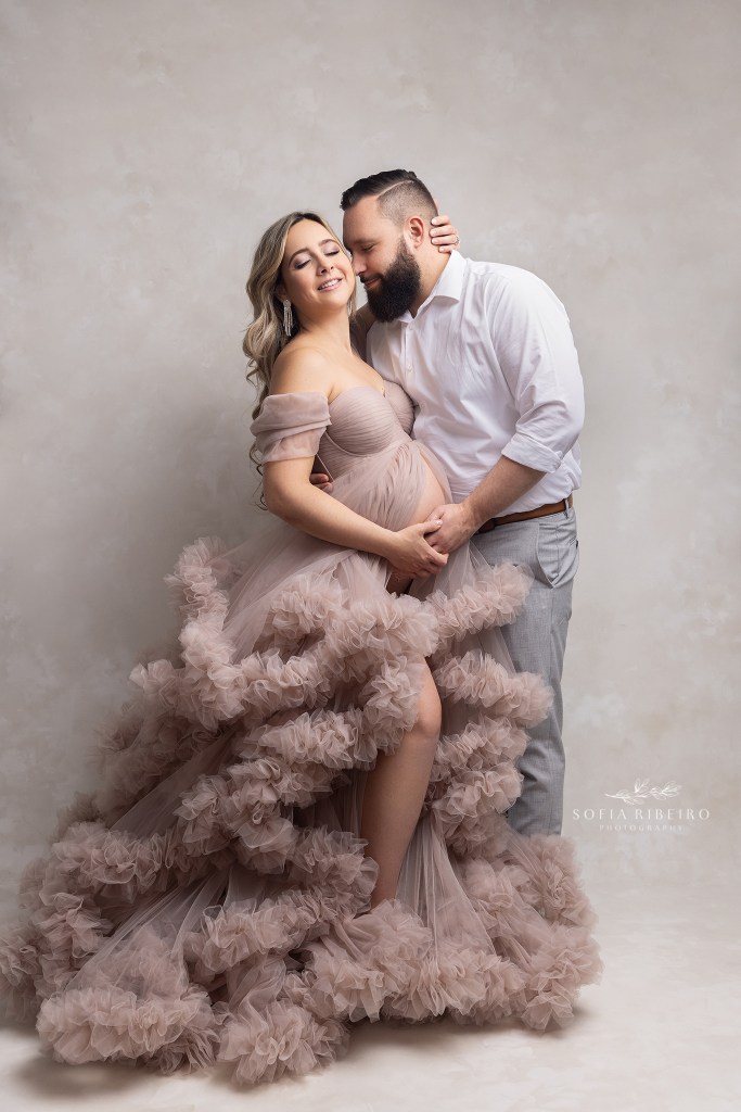 mom and dad share a moment posing together during a nj maternity photo session in clark nj