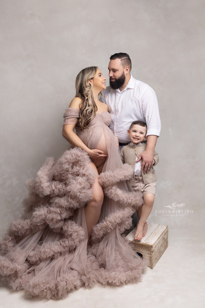 mom dad and toddler son share a moment during a maternity photo session in nj