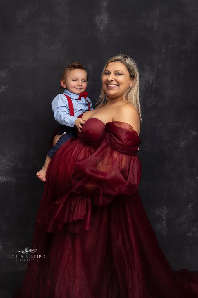 mom holds son next to her belly during a maternity session in roselle park nj