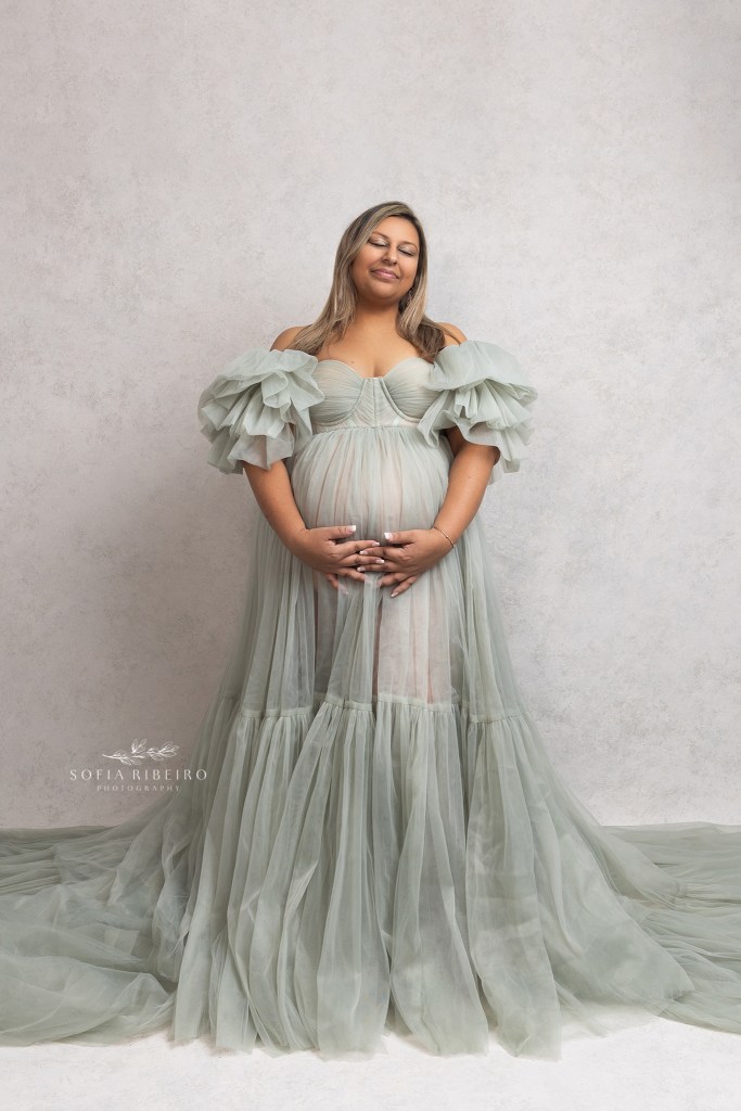 mom poses solo in a mint green ruffled gown during her maternity session in roselle park nj