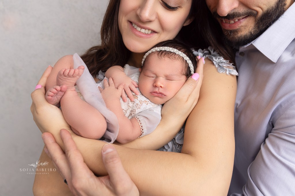 mom and dad pose with baby during a session with a colonia nj newborn photographer