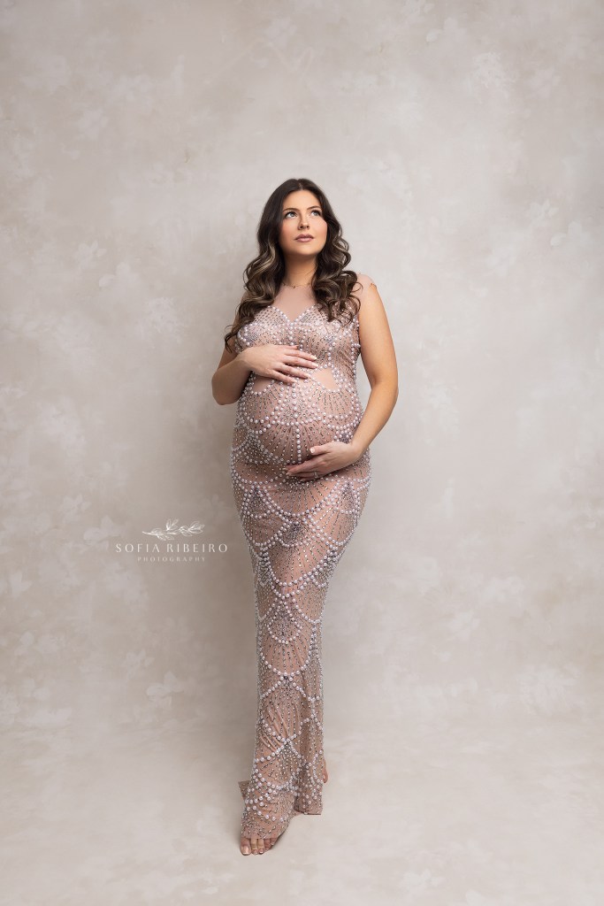 mom poses in a beaded gown showing off her bump during a maternity photo session in dover nj