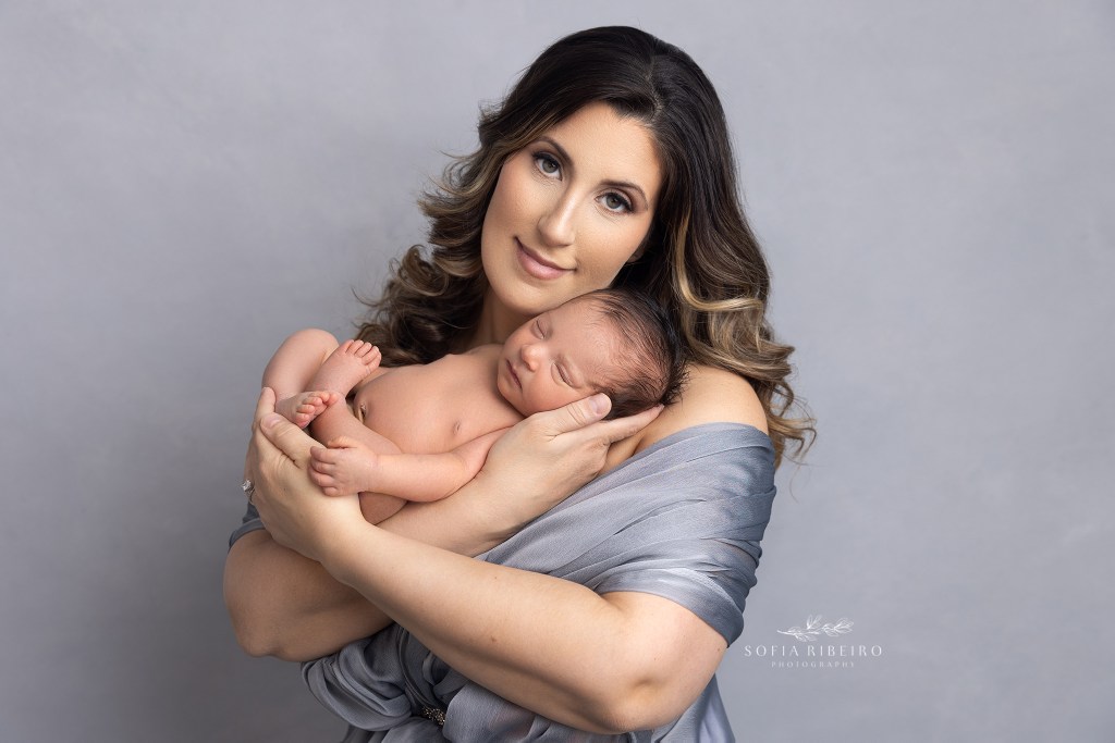 mom lovingly snuggles her newborn son in between poses during a session with a garwood nj newborn photographer