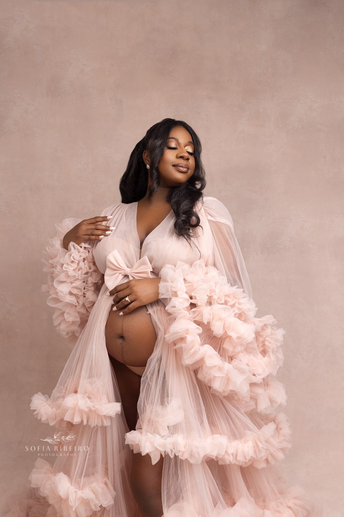 a closeup of mom cradling her belly during a maternity photo session in nj