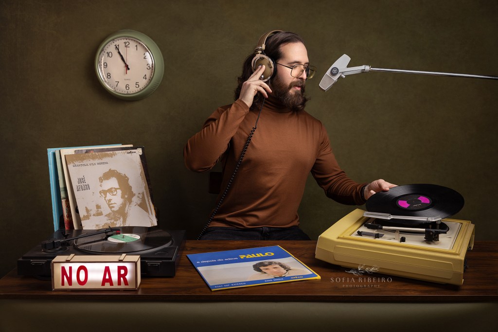 a model poses as a dj placing the initial disc indicating the start of portugal's carnation revolution. Um locutor da radio mete o primeiro disco do paulo carvalho a sinalizar o inicio da revolucao de dia 25 de abril