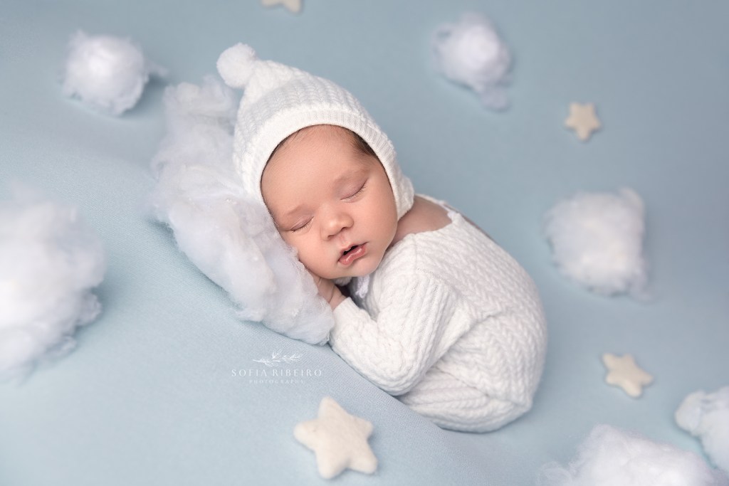 baby posed on pillow cloud tufts sweetly sleeping
