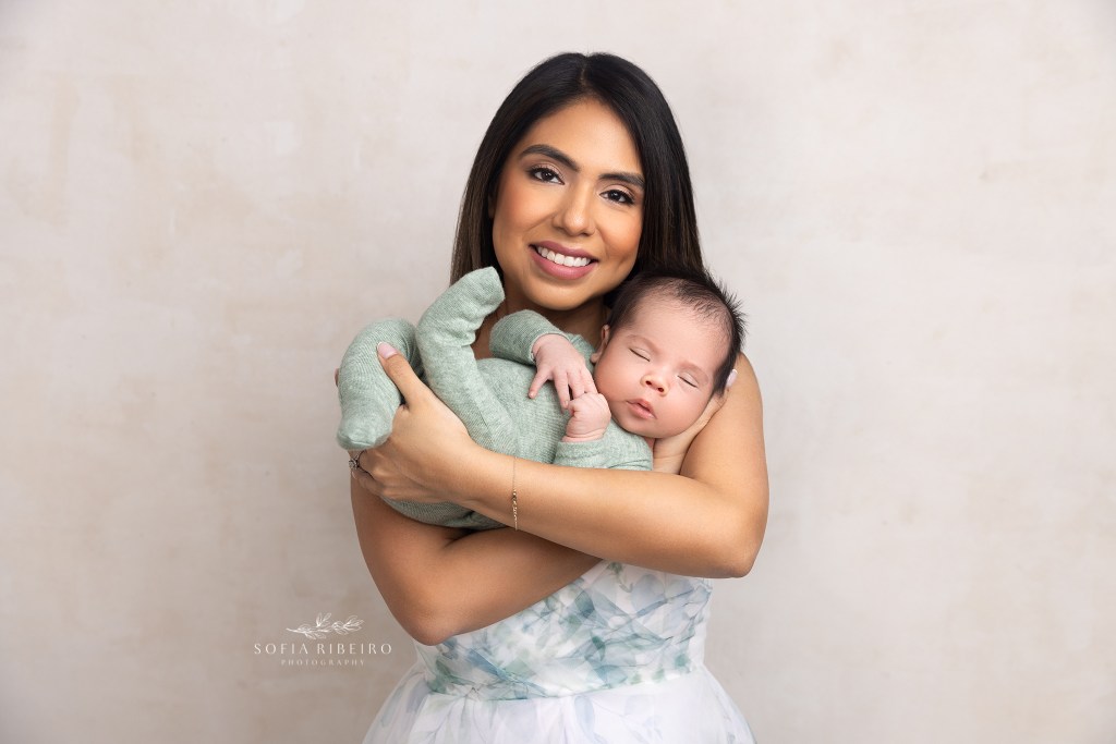 mom snuggles her newborn baby during a session in scotch plains nj