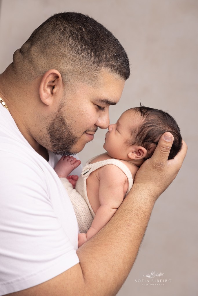 dad snuggles nose to nose with his baby boy