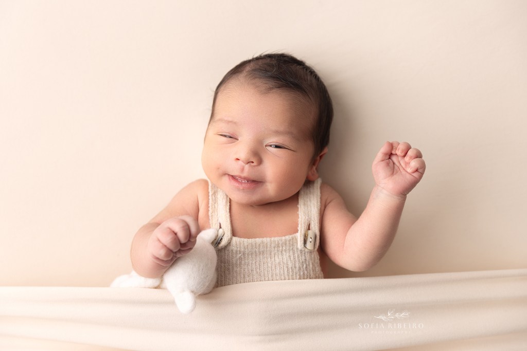 baby boy makes a silly face during his newborn session in wharton nj