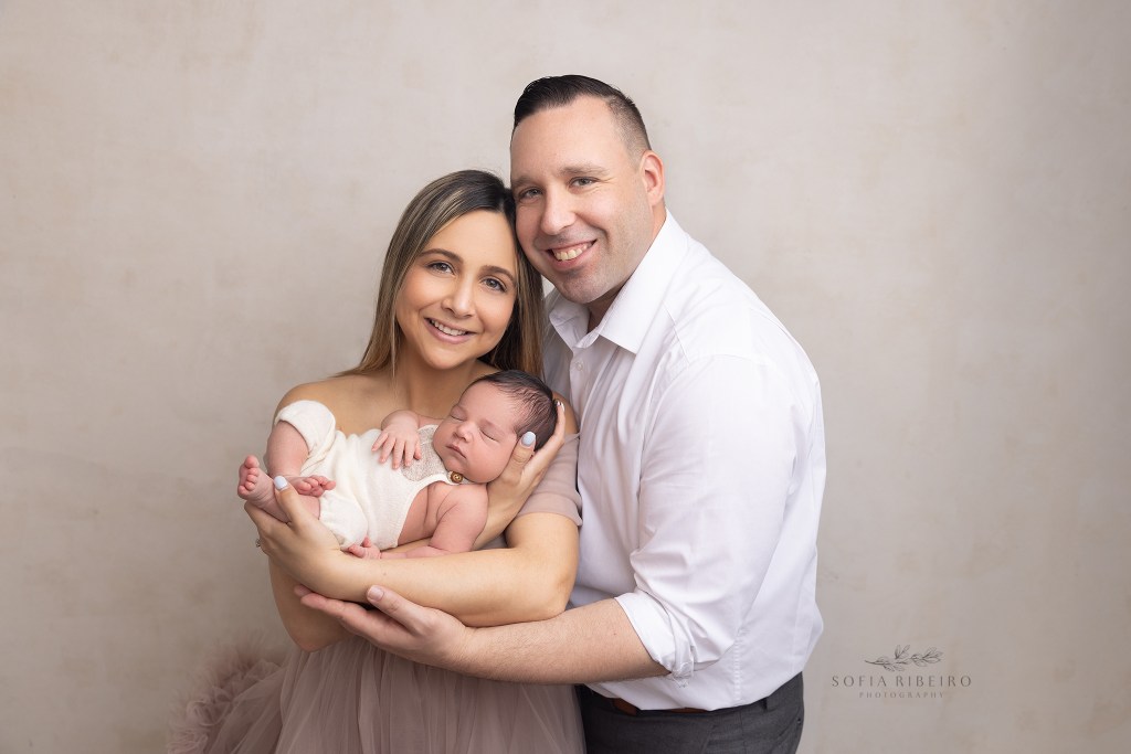 mom and dad snuggle their new little baby during a photo session in clark nj
