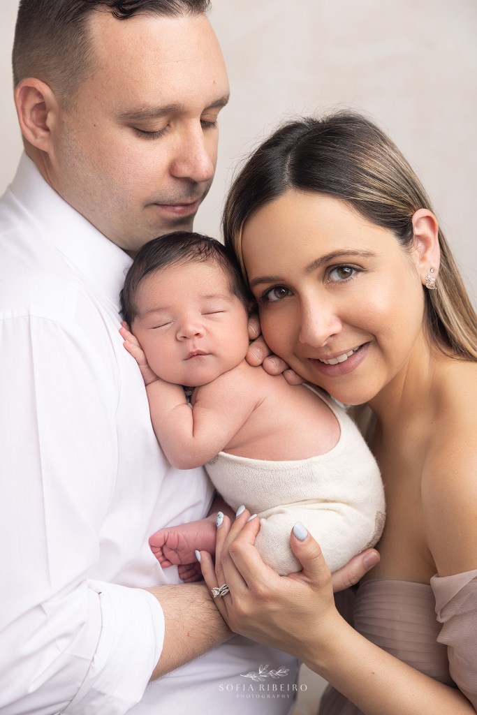 mom and dad snuggle their new little baby during a photo session in clark nj