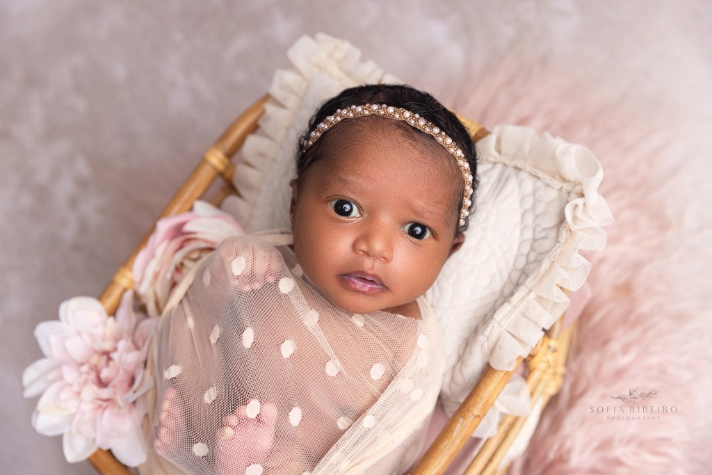 newborn baby stares into the camera during her photo session in bloomfield nj