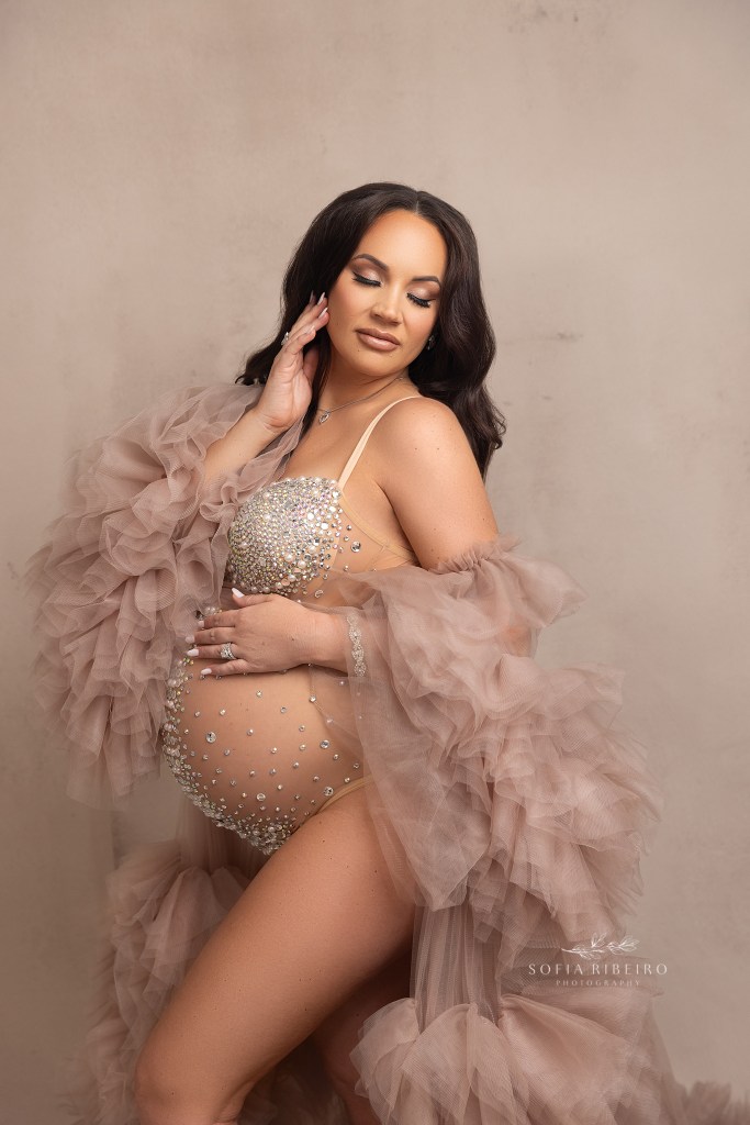 mom poses in a tulle robe and bedazzled bodysuit for a maternity session in edison nj
