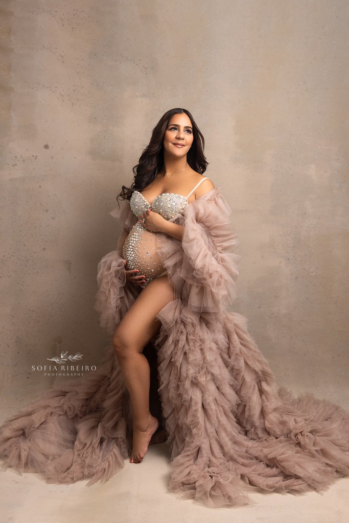 a pregnant mom dazzles in a sparkly bodysuit and ruffled robe during a maternity session with a north bergen nj photographer