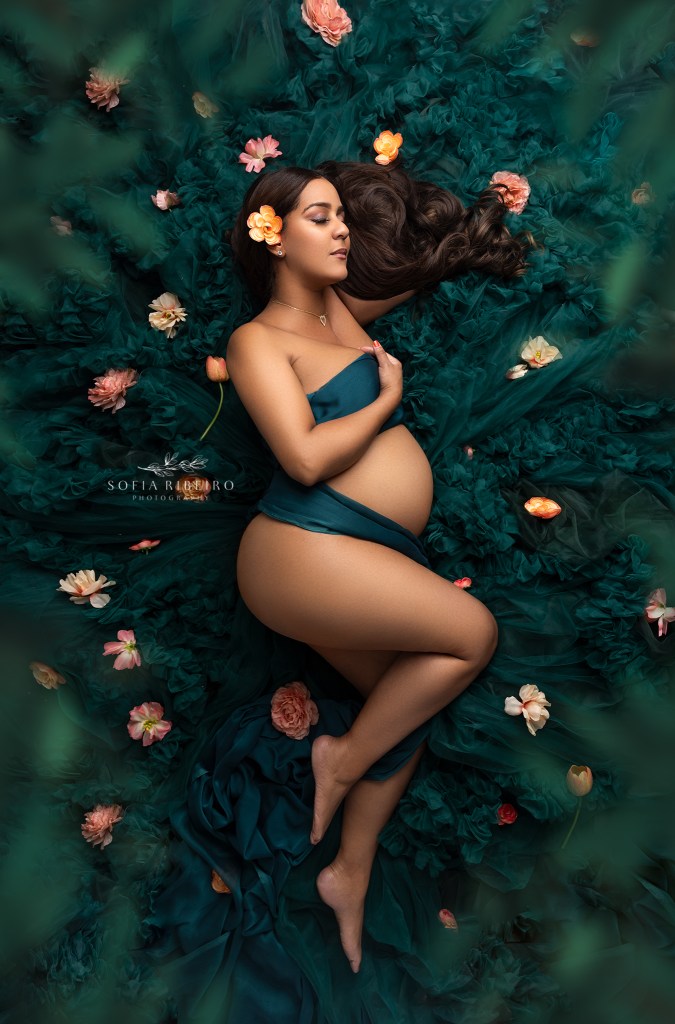 a mom poses in green tulle during a maternity photo session in north bergen nj