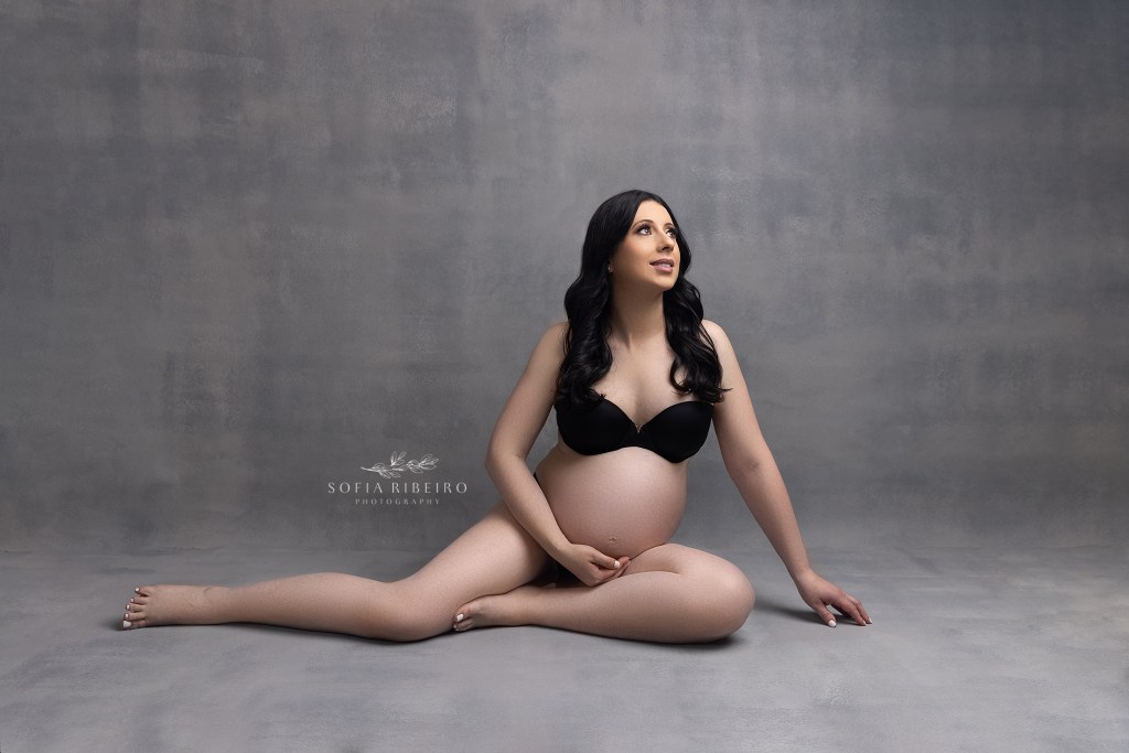 mom strikes a powerful pose in lingerie with baby bump exposed