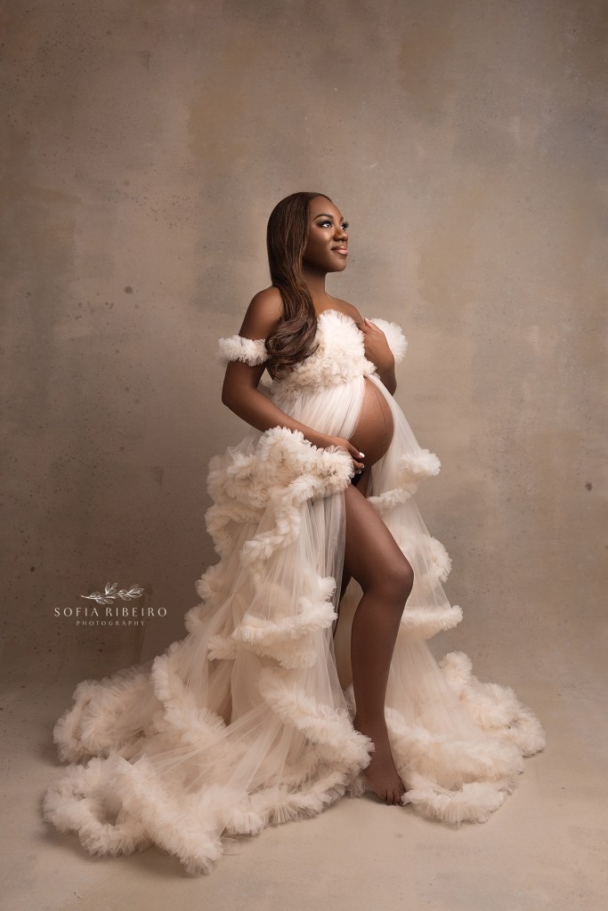 mom poses regally in a tulle maternity gown showcasing her baby bump with a nj maternity photographer