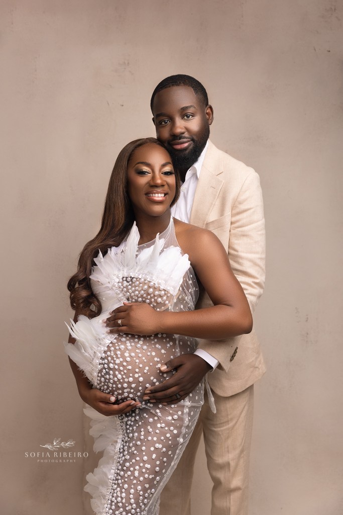 mom and dad cradle the baby bump lovingly during a maternity session in nj