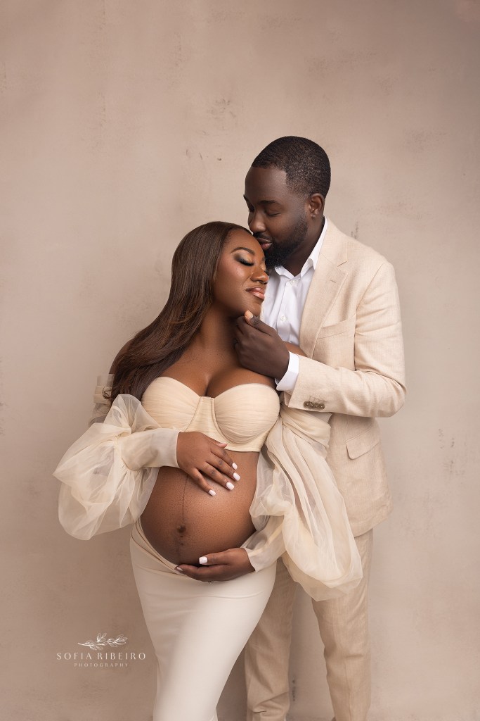 mom and dad cradle the baby bump lovingly during a maternity session in nj