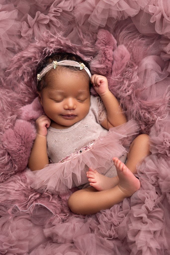 a newborn baby girl posed in tulle during a session with a nj newborn photographer