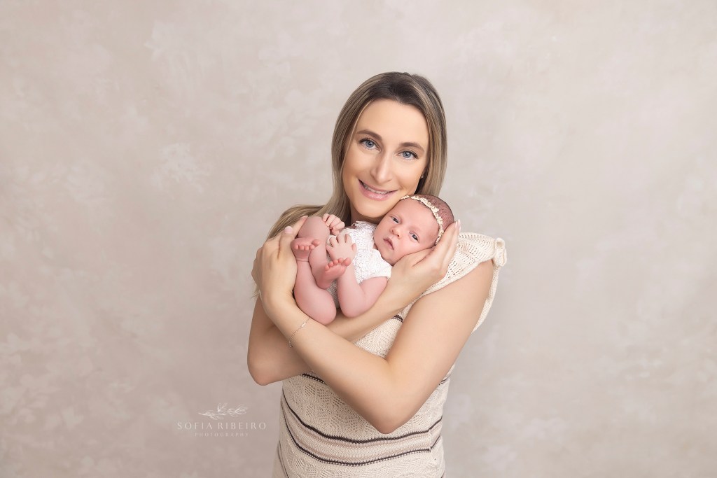 mom cradles baby lovingly for a newborn portrait in monroe nj