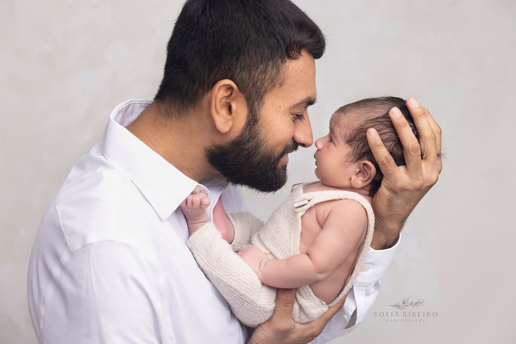 dad gives his new baby boy eskimo kisses during a photo session in a staten island newborn photography studio
