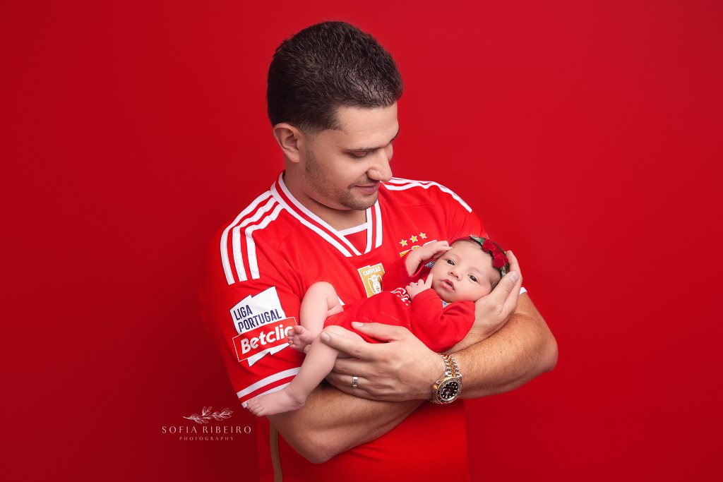 dad wears his favorite jersey holding his new baby girl in a matching one in belleville nj