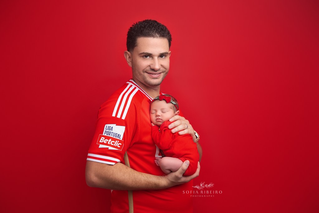 dad wears his favorite jersey holding his new baby girl in a matching one in belleville nj