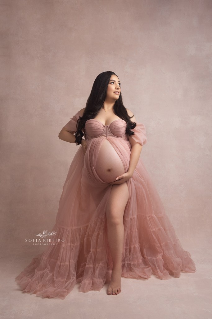 mom poses exposing her baby bump during a portrait session with hackensack nj maternity photographer