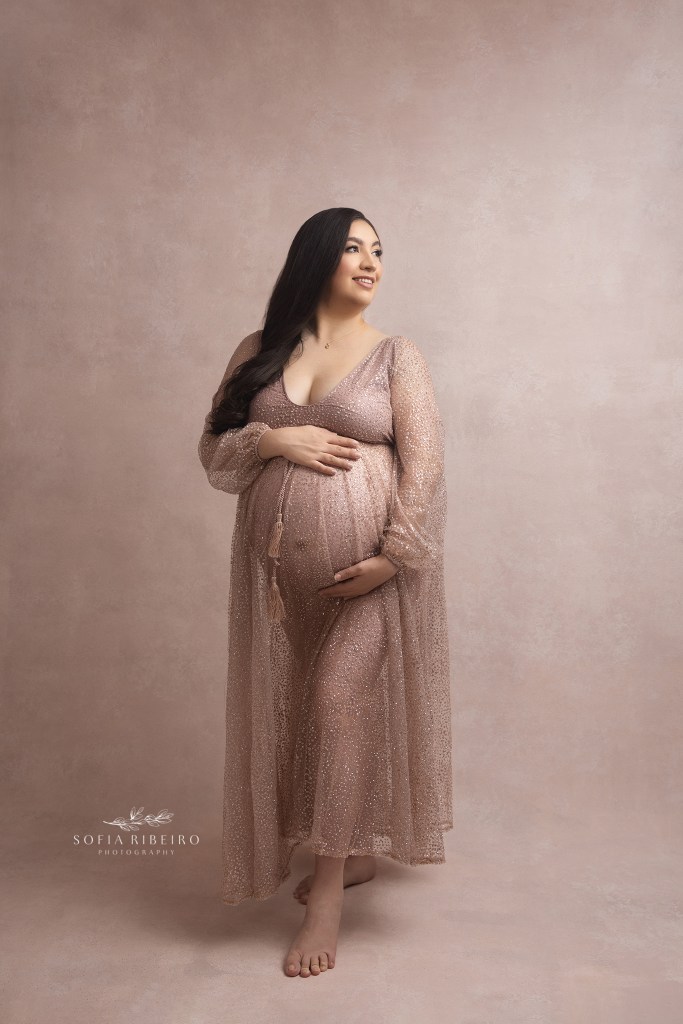 mom stands posing with hands around her belly during a session with hackensack nj maternity photographer