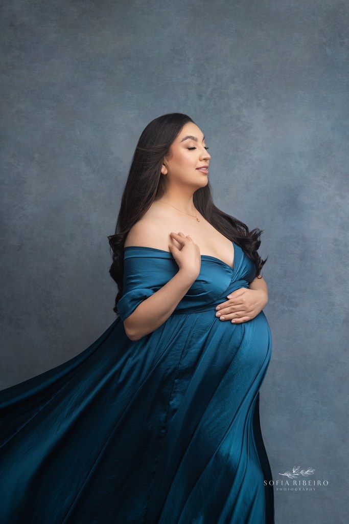 mom poses with delicate hands on her body during a maternity session in hackensack nj