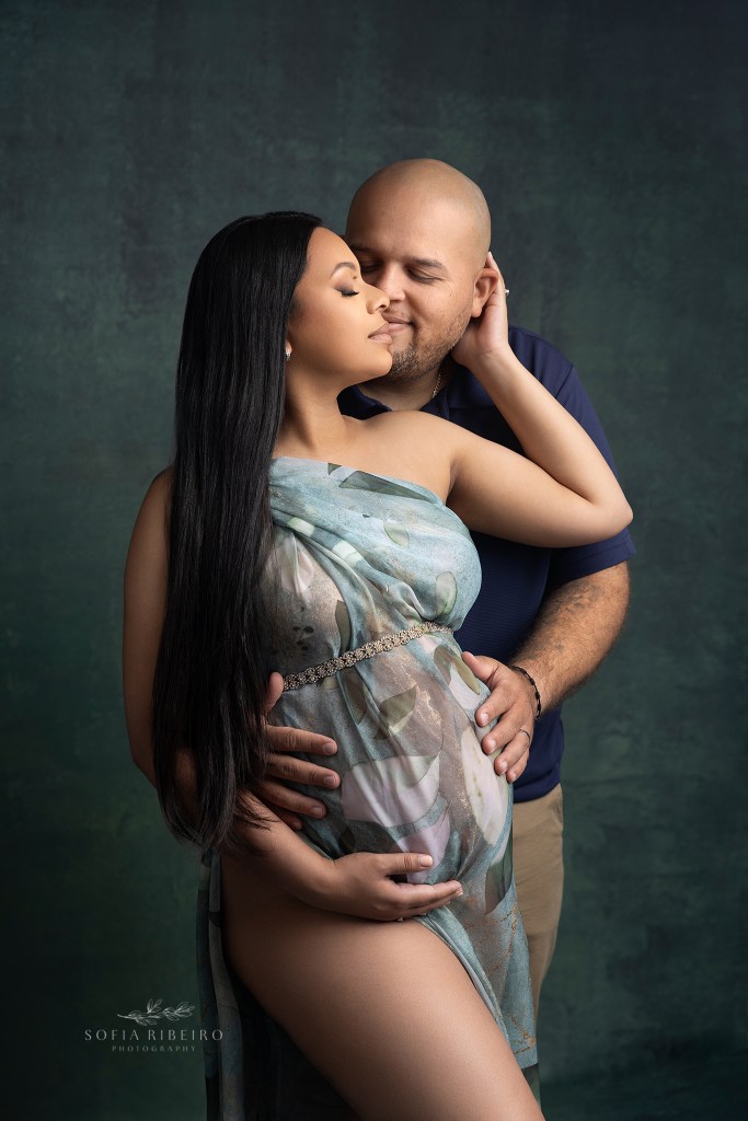 mom and dad share a sweet moment during maternity photos