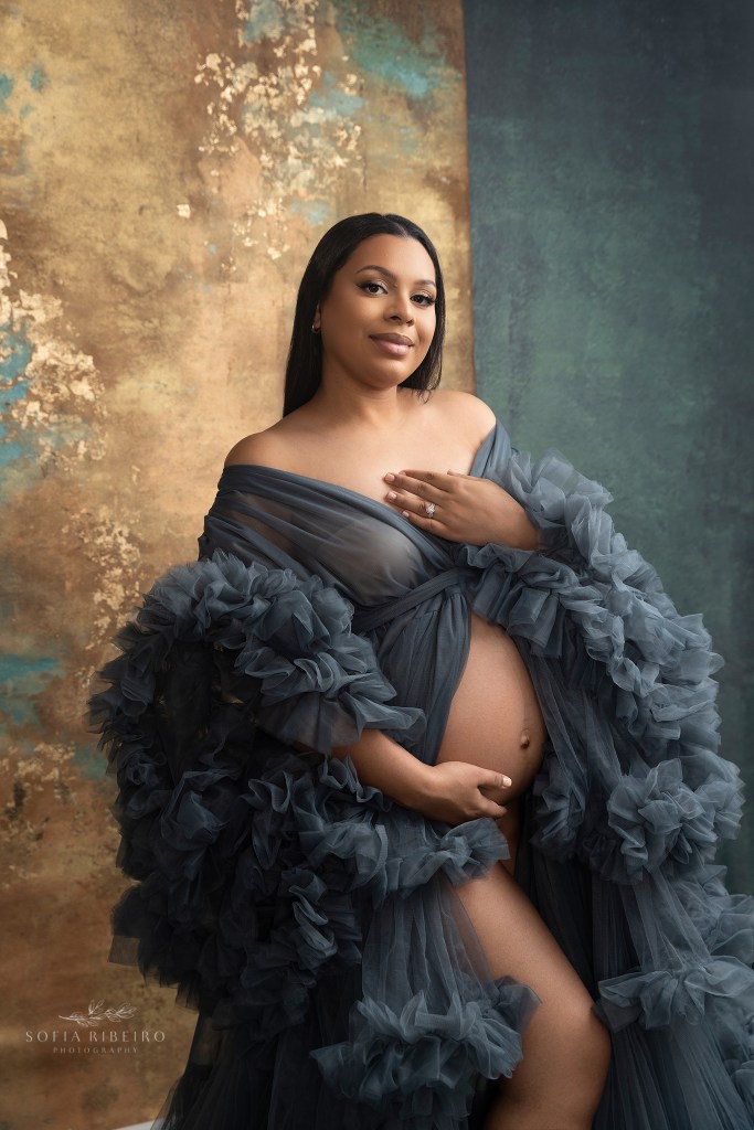 mom poses with exposed belly during photos to celebrate her pregnancy in hudson ny