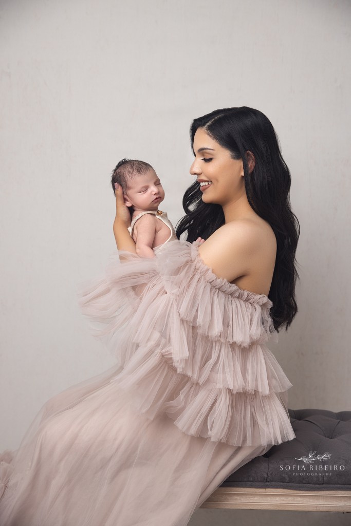 pennsylvania newborn photographer poses mom holding baby and smiling sweetly at him