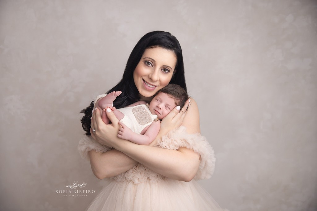 mom and baby both smile at the camera during their baby's newborn session with a south amboy nj newborn photographer