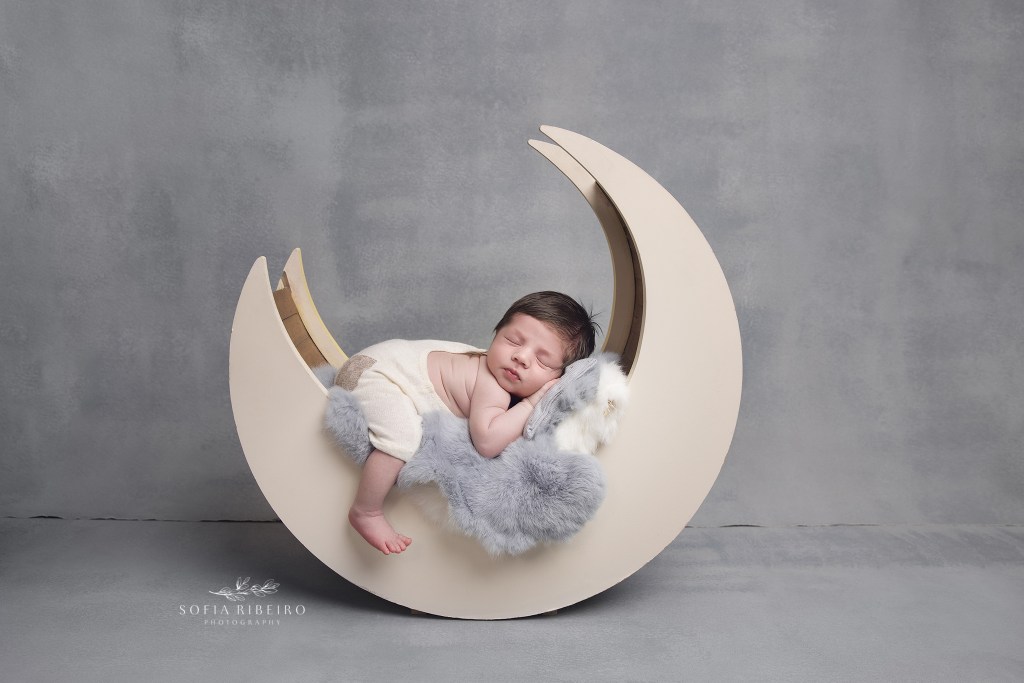 south amboy nj newborn photographer poses a baby boy on a moon prop for photos