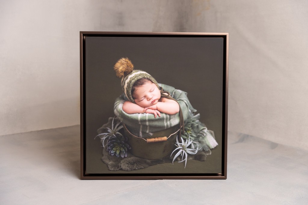 a showcase of wall art piece with a floating frame of a newborn baby