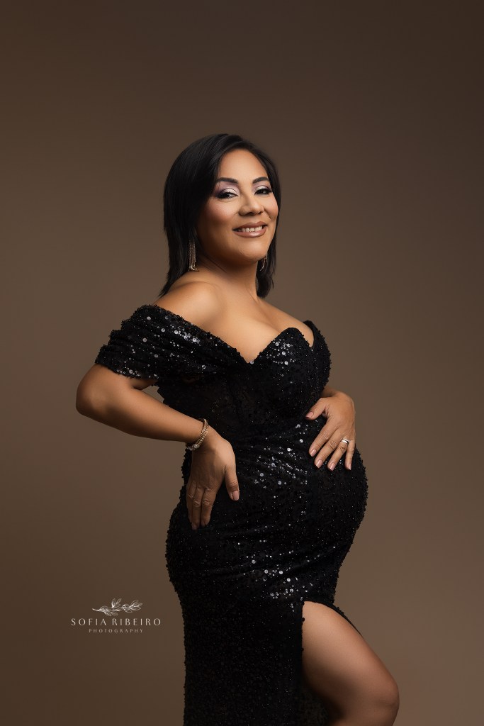 a sparkly black gown highlights a pregnant mom to be in maternity photos