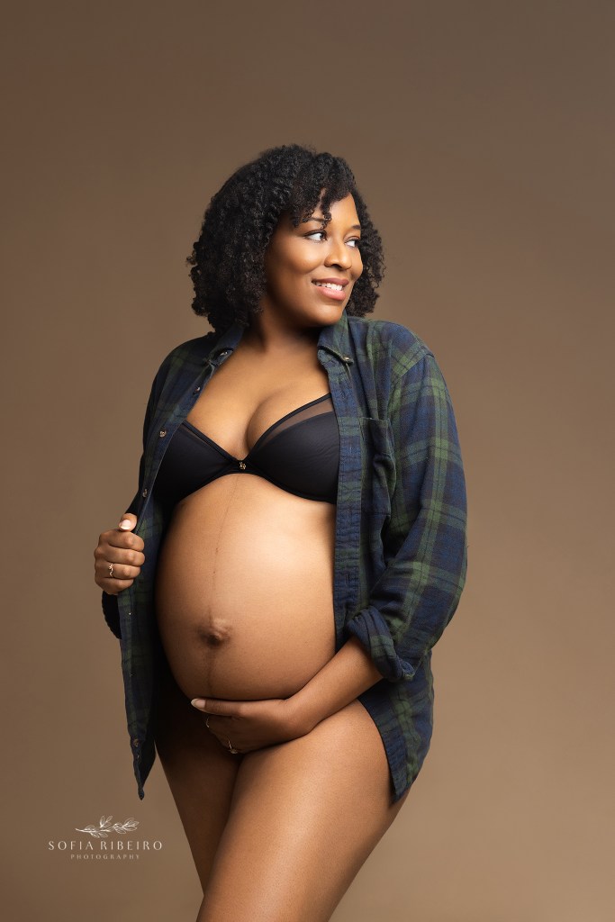 mom wears a sentimental plaid shirt with a black bra and panties exposing her beautiful baby bump for a portrait in union city nj