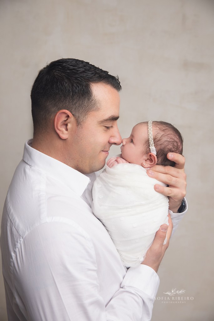 dad holds his baby girl nose to nose for a portrait