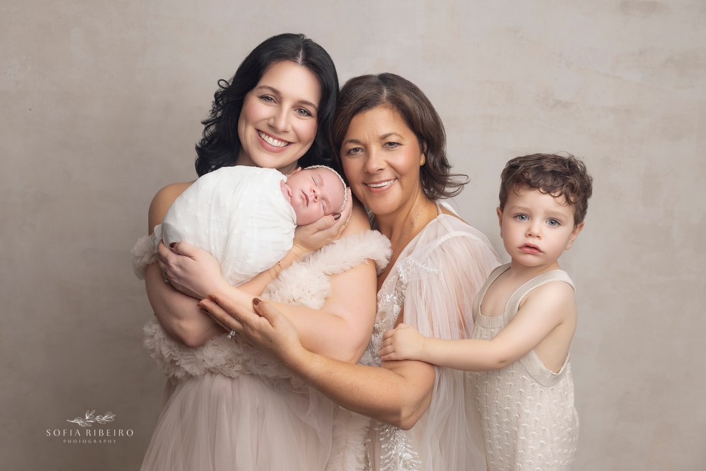 a newborn portrait with baby girl, mom, grandma, and big brother in bernards nj