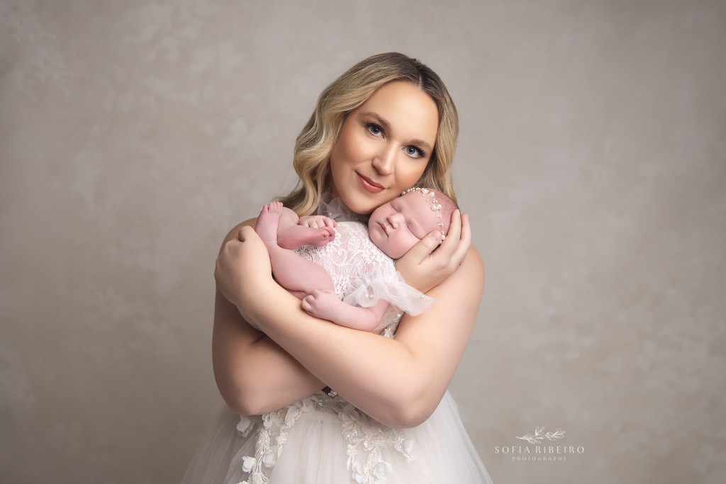 mom snuggled newborn baby girl in a photo by south plainfield nj newborn photographer
