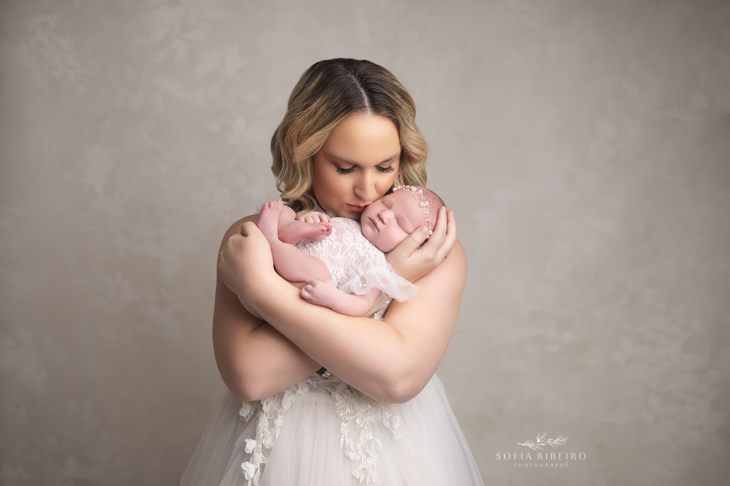 mom snuggled newborn baby girl in a photo by south plainfield nj newborn photographer