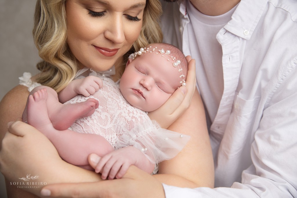 mom and dad pose together in a sweet image with their baby girl taken in a south plainfield nj newborn photography studio