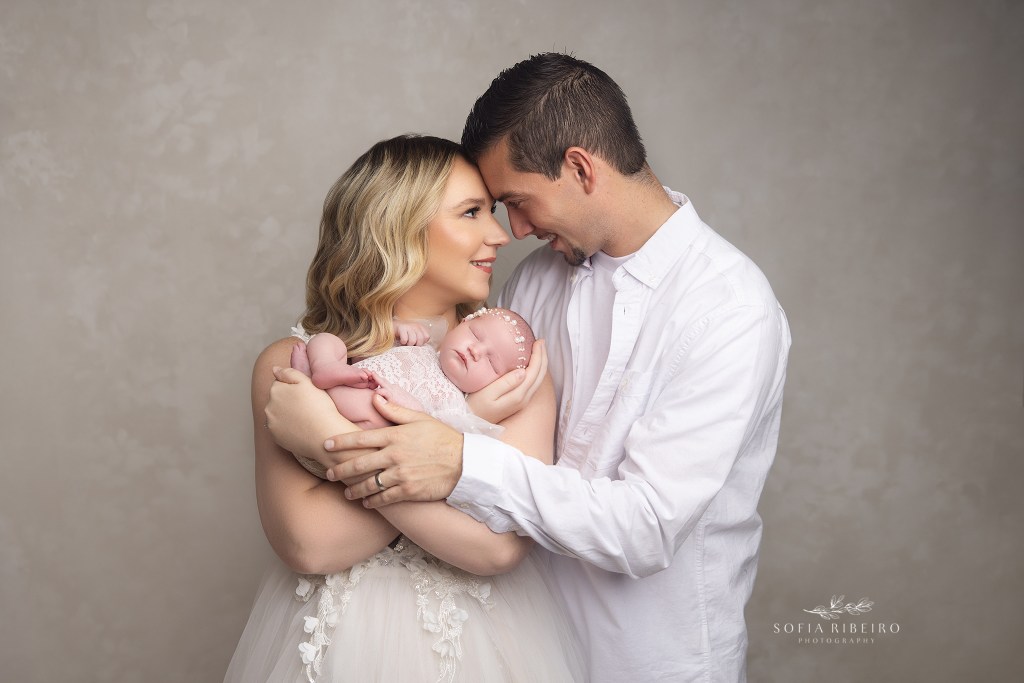 mom and dad pose together in a sweet image with their baby girl taken in a south plainfield nj newborn photography studio