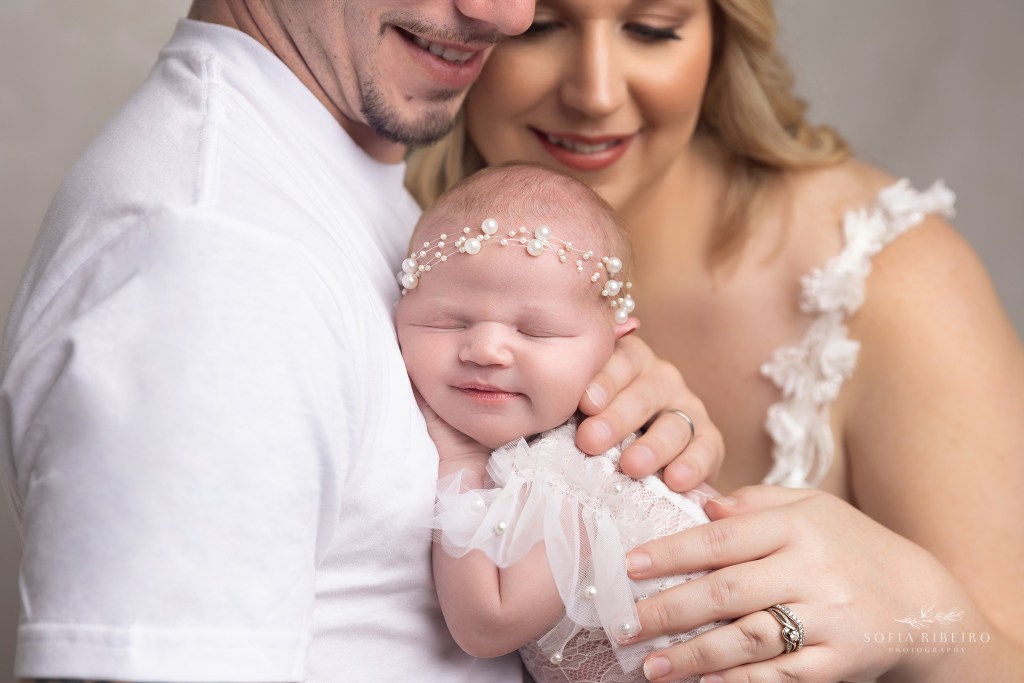 mom and dad pose together in a sweet image with their baby girl taken in a south plainfield nj newborn photography studio