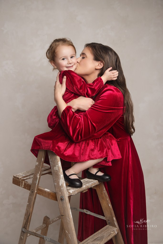 mom shares a sweet moment with her toddler and a cuddly kiss
