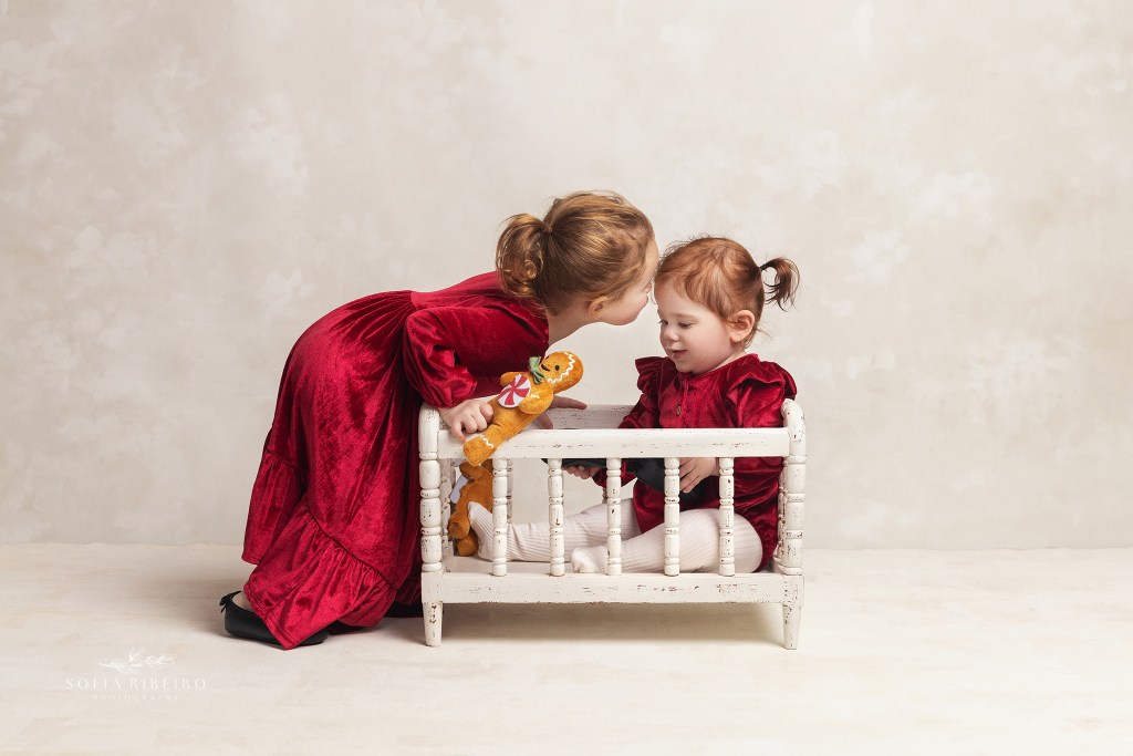 two little girls play together during a family photo session in wallington nj